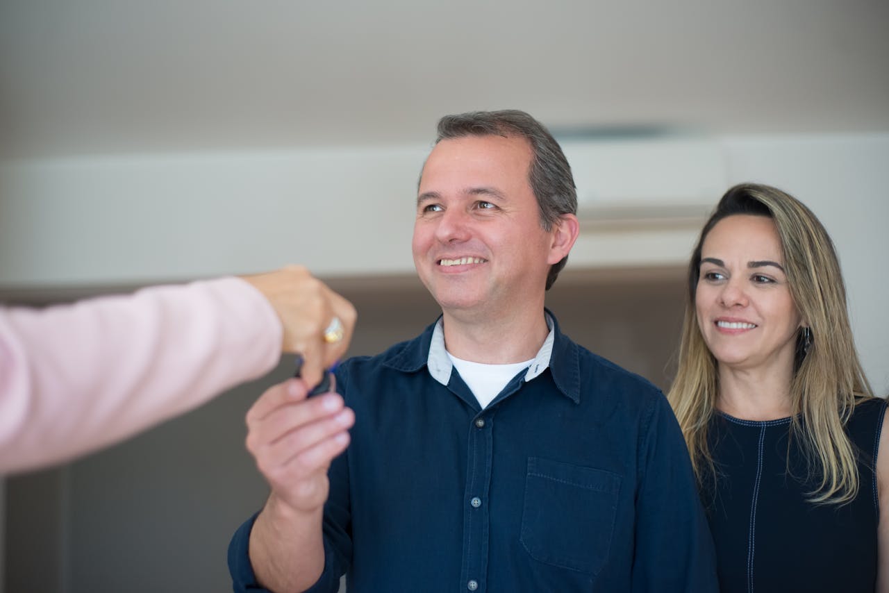 Crafting Captivating Headlines: Your awesome post title goes here Smiling couple receiving keys, celebrating new home purchase indoors.